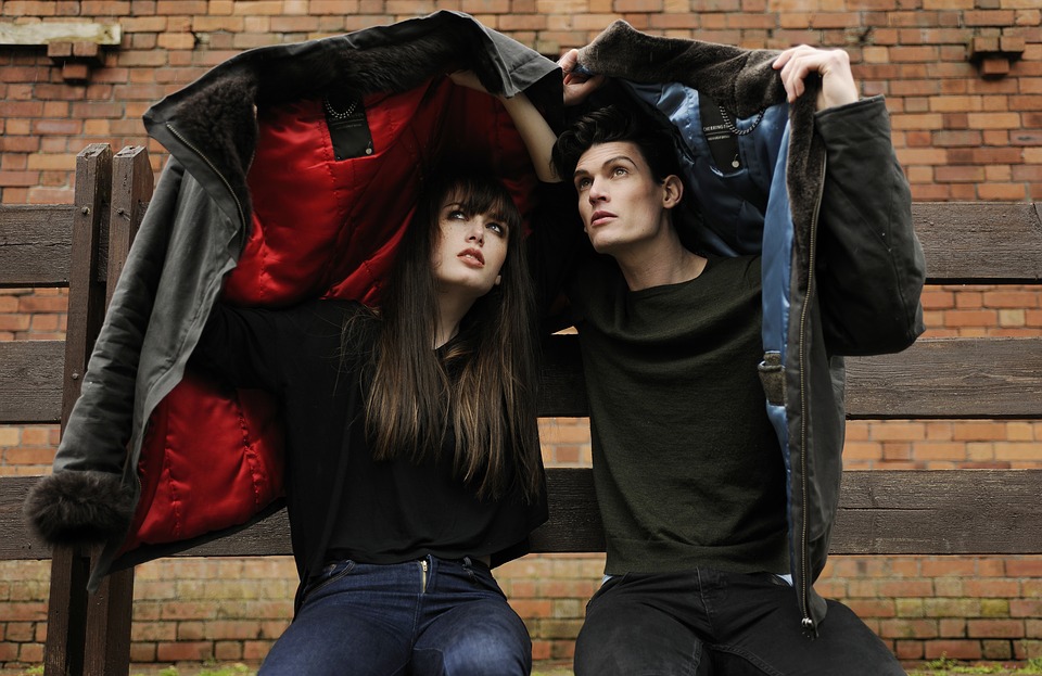 couple using their jackets as a shield